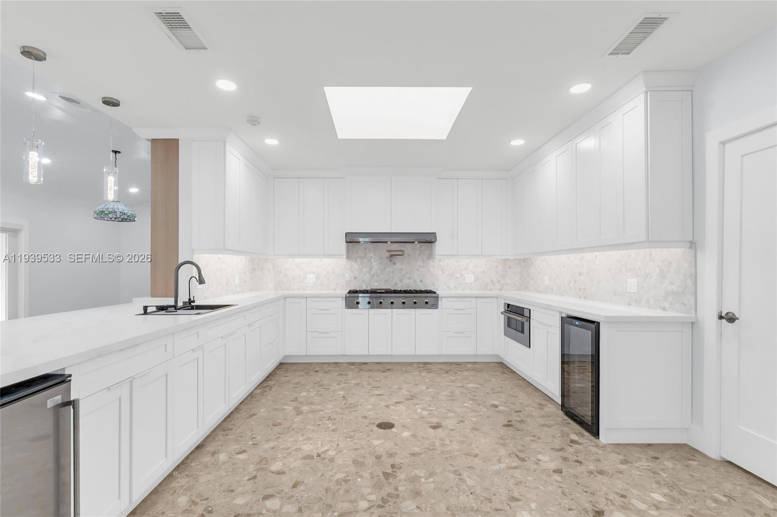 11835 Southwest 47th Street Miami, FL 33175 - Photo 22 of 48 a large kitchen with stainless steel appliances a large counter top a stove and a sink