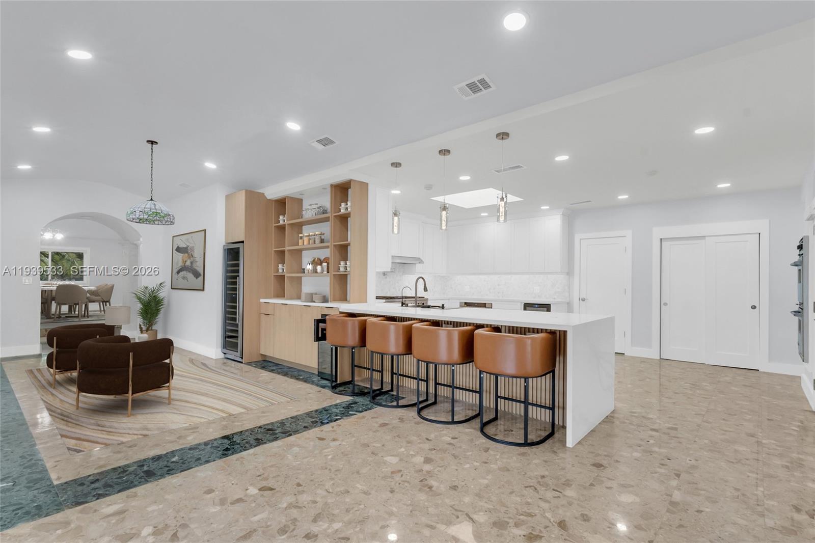 11835 Southwest 47th Street Miami, FL 33175 - Photo 27 of 48 a large kitchen with a large counter top appliances and a living room view