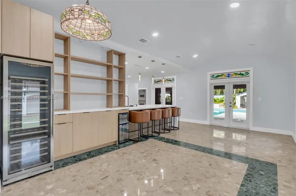 a large white kitchen with a large window