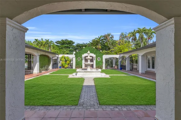a front view of a house with a yard and porch