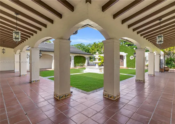 a front view of a house with swimming pool having outdoor seating