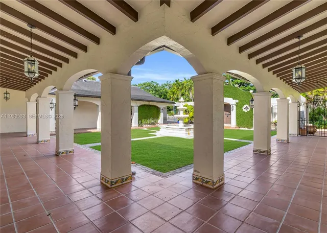 a front view of a house with swimming pool having outdoor seating