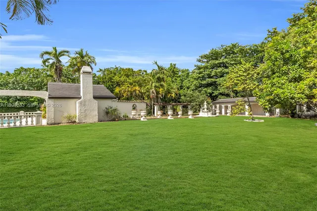 a garden with trees in front of it