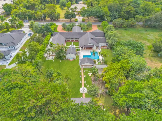 a aerial view of a house with a garden and lake view