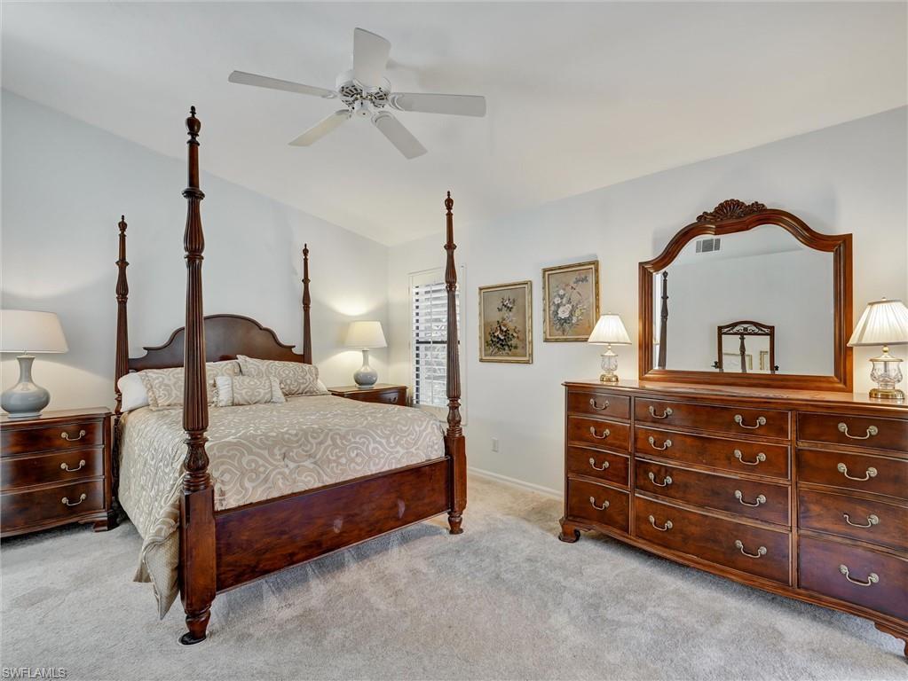 241 St James Way Naples, FL 34104 - Photo 15 of 34 Bedroom featuring light colored carpet and ceiling fan