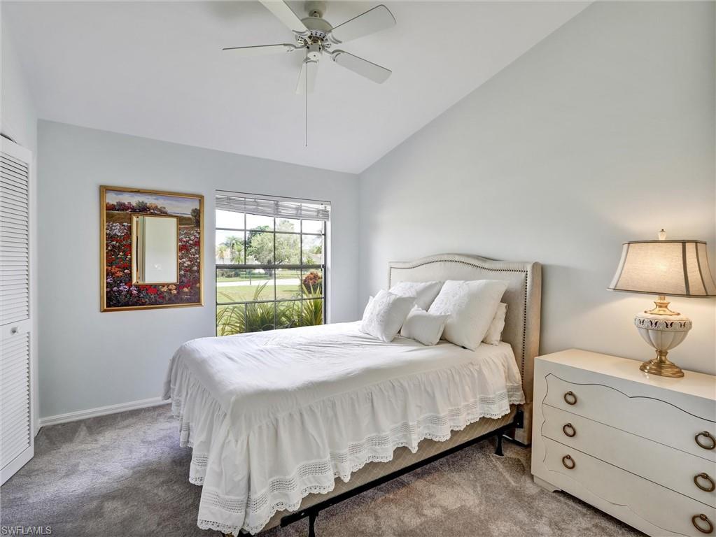 241 St James Way Naples, FL 34104 - Photo 18 of 34 Bedroom featuring lofted ceiling, carpet, ceiling fan, and a closet