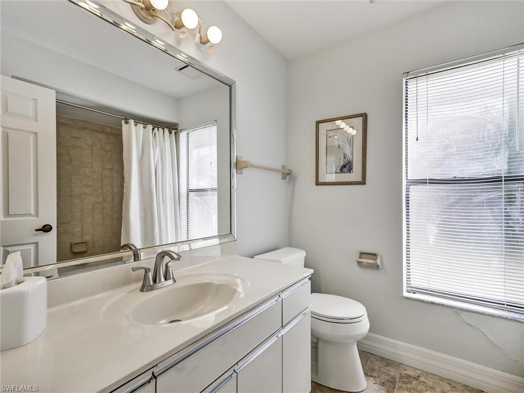 241 St James Way Naples, FL 34104 - Photo 19 of 34 Full bath with vanity and a shower with curtain