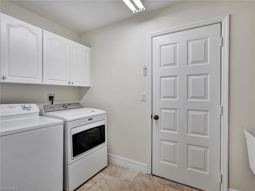 241 St James Way Naples, FL 34104 - Photo 20 of 34 Laundry area featuring washing machine and clothes dryer and cabinet space