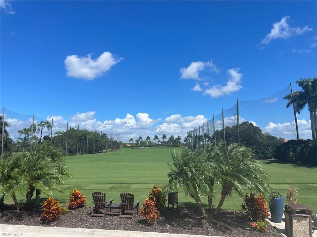 241 St James Way Naples, FL 34104 - Photo 32 of 34 View of community featuring a lawn, golf course view, and view of wooded area