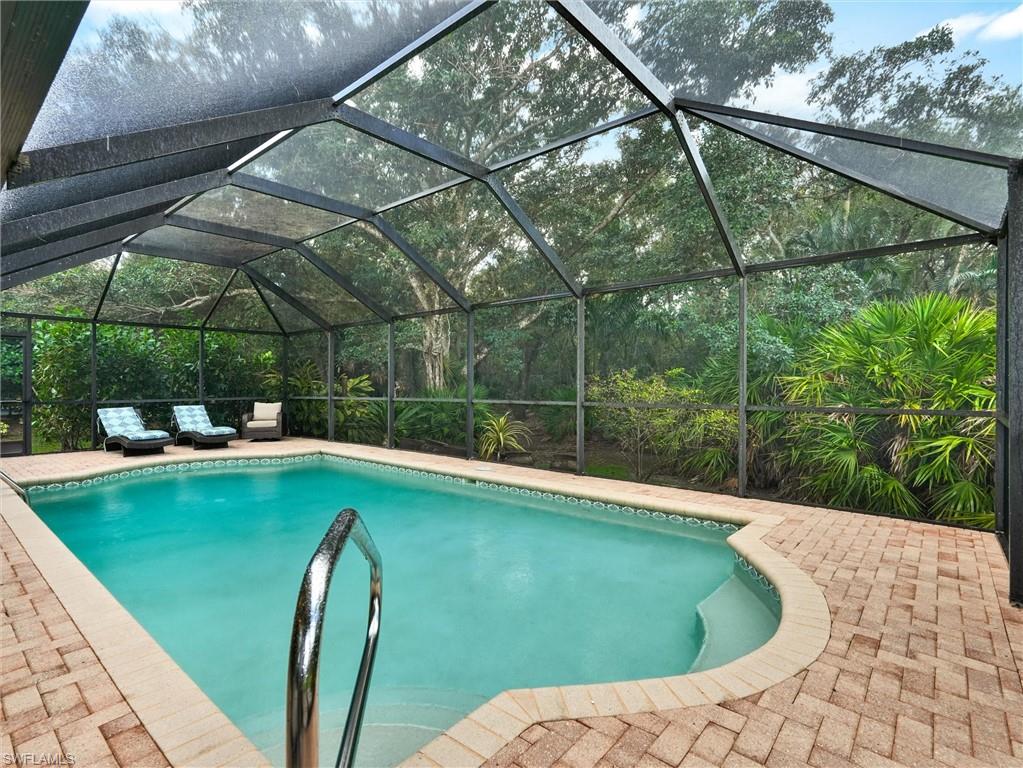 241 St James Way Naples, FL 34104 - Photo 4 of 34 Swimming pool featuring a lanai, a sunroom, and a patio