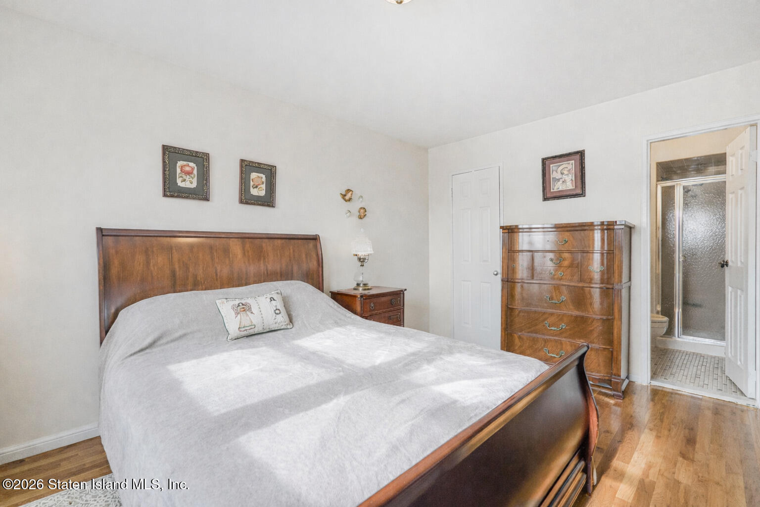 76 Berry Avenue Staten Island, NY 10312 - Photo 21 of 42 a bedroom with a bed and wooden floor