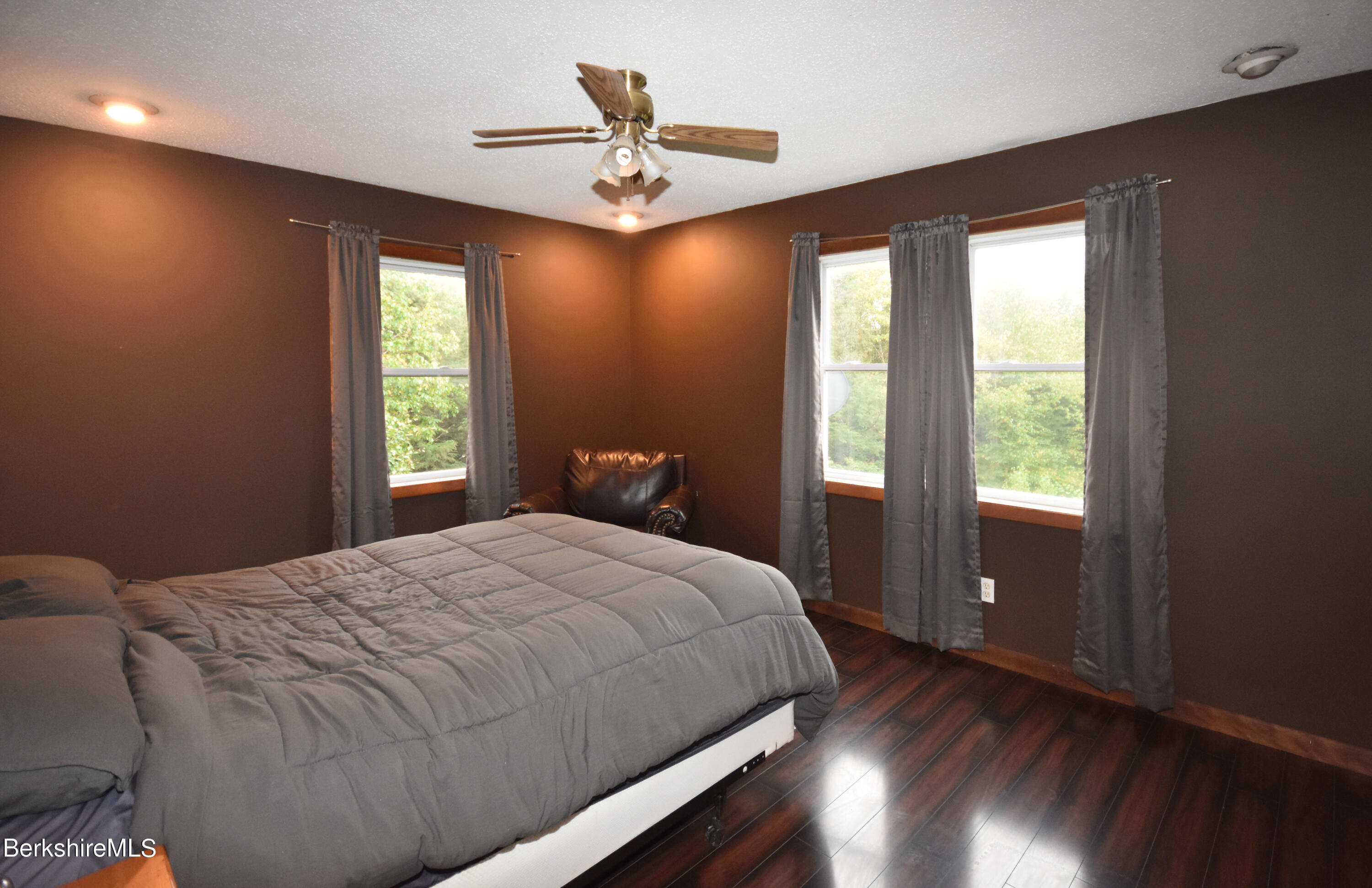206 Sam Hill Road Worthington, MA 01098 - Photo 22 of 40 a bedroom with a large bed chandelier and a window