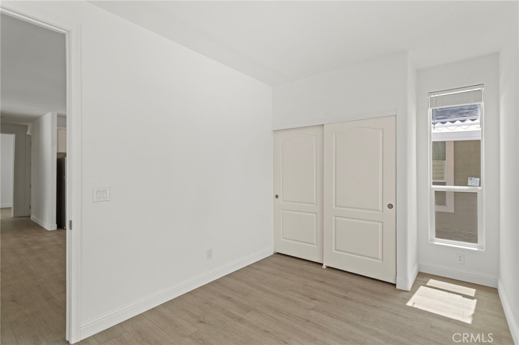 22113 Grand Terrace Road, Unit 7 Grand Terrace, CA 92313 - Photo 12 of 16 an empty room with wooden floor