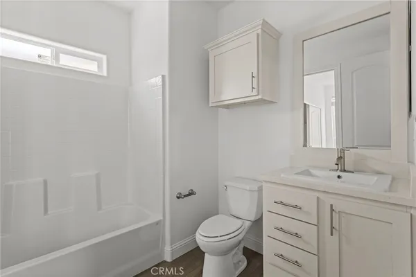 a bathroom with a sink toilet vanity and tub