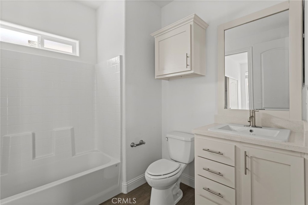 22113 Grand Terrace Road, Unit 7 Grand Terrace, CA 92313 - Photo 14 of 16 a bathroom with a sink toilet vanity and tub
