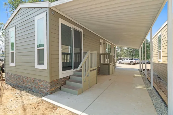 a view of a house with backyard and porch