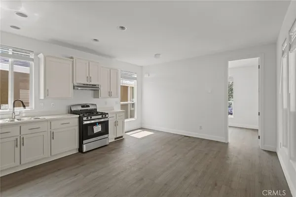 a kitchen with granite countertop a stove and a sink
