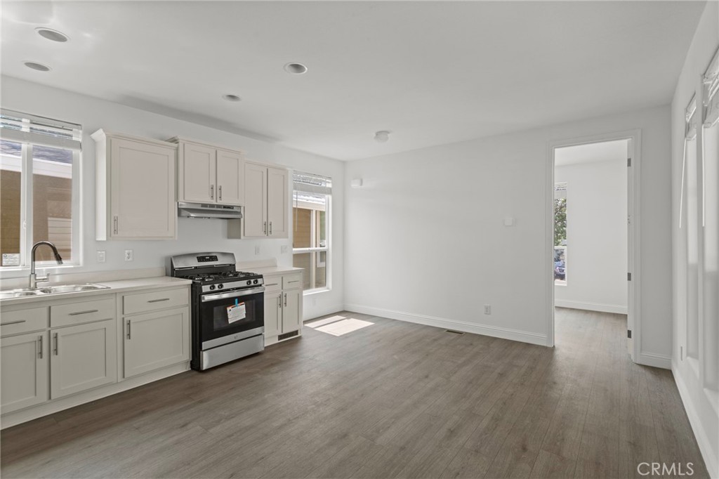22113 Grand Terrace Road, Unit 7 Grand Terrace, CA 92313 - Photo 4 of 16 a kitchen with granite countertop a stove and a sink