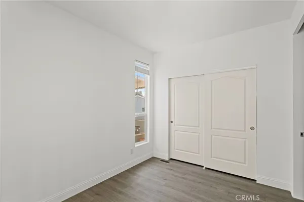 a view of an empty room and wooden floor