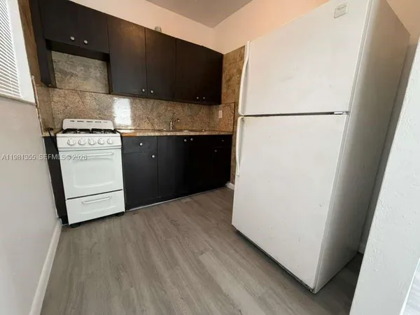 a kitchen with a refrigerator and a stove