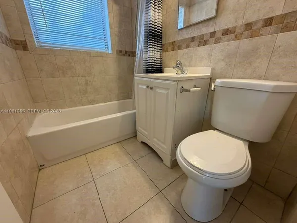 a bathroom with a toilet and a bathtub