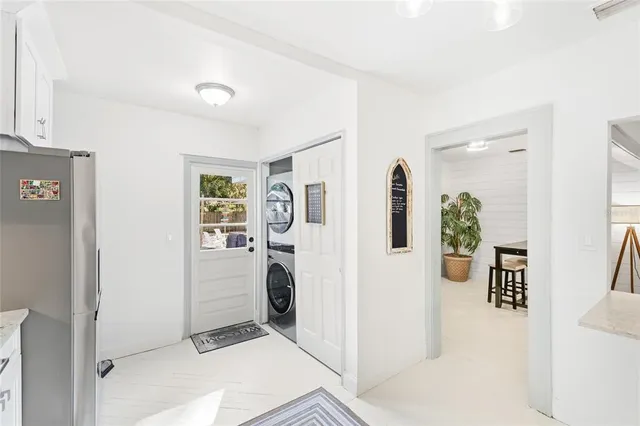 a view of a kitchen with fridge and workspace