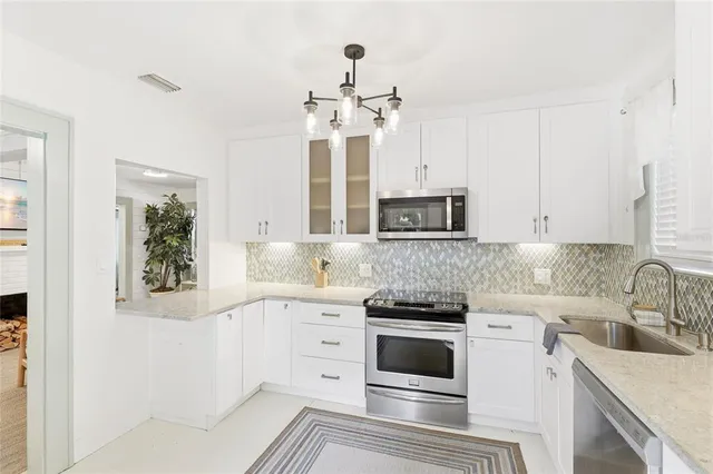 a kitchen with a sink stove and cabinets