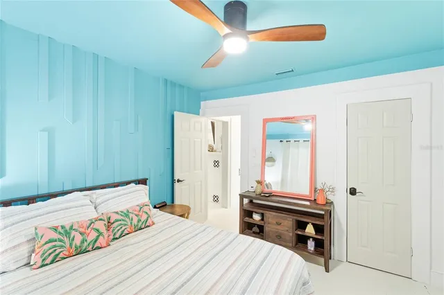 a bedroom with a bed and a chandelier