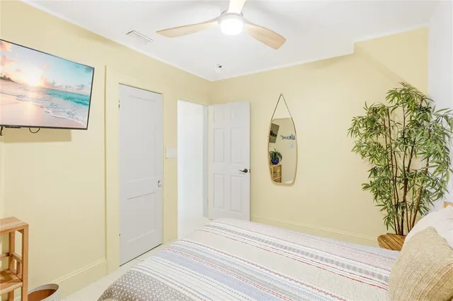 a view of a bedroom with wooden floor and cabinet