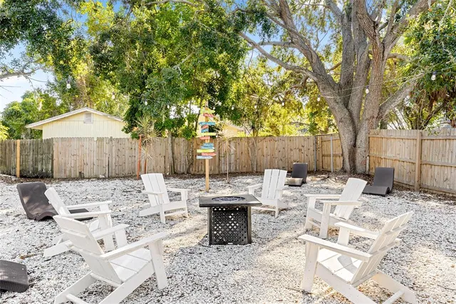 a view of a wooden bench and lounge chairs