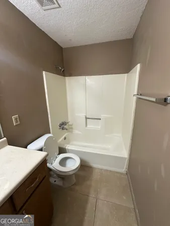 an empty room with a window and a ceiling fan
