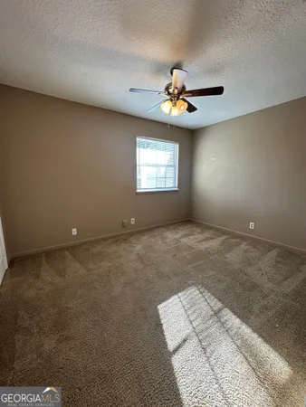 a view of a livingroom with a ceiling fan and window
