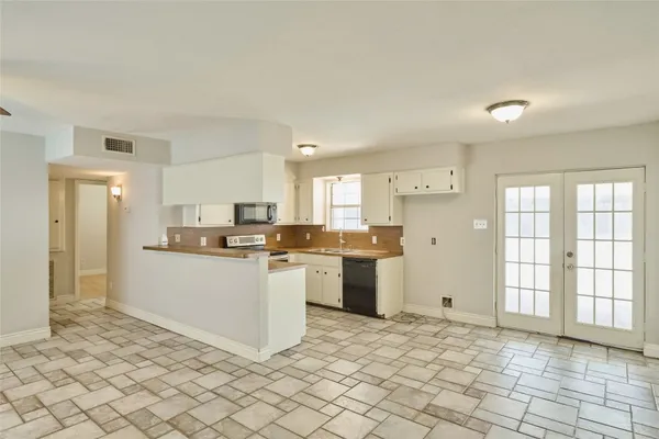 a kitchen with a refrigerator and a sink