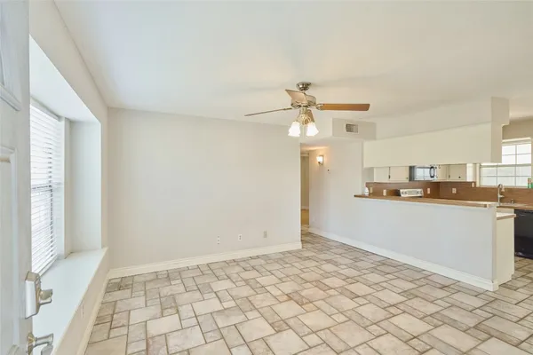 a view of a kitchen with a sink and cabinets