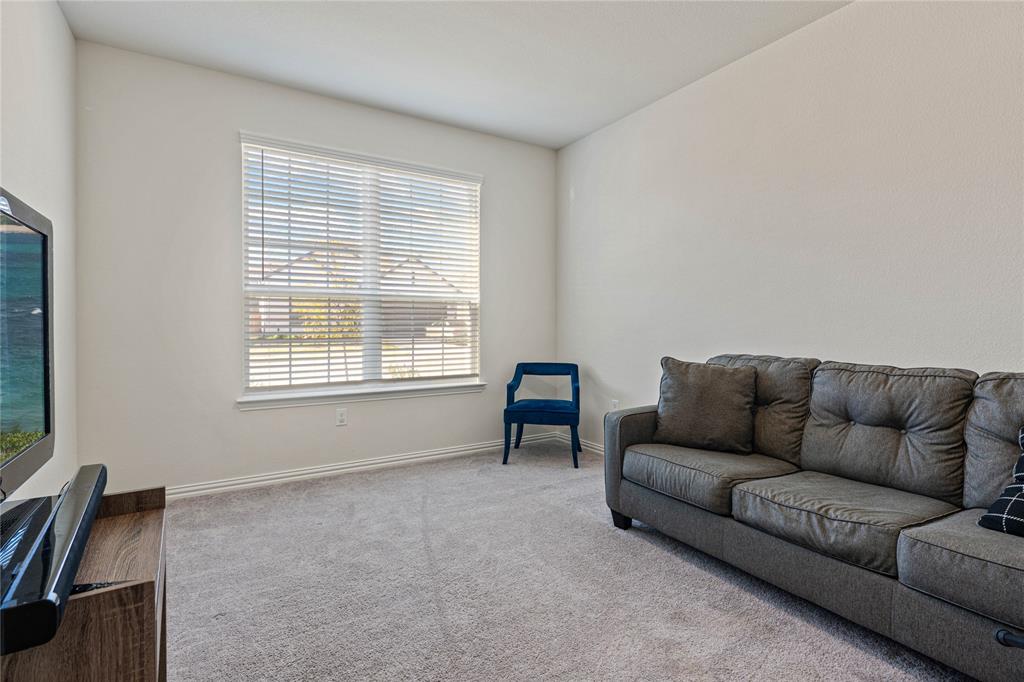 9517 Sunset Lane Oak Point, TX 75068 - Photo 5 of 40 9517 Sunset Lane, Oak Point, TX 75068 - Bedroom - downstairs guest bedroom featuring light carpet and baseboards