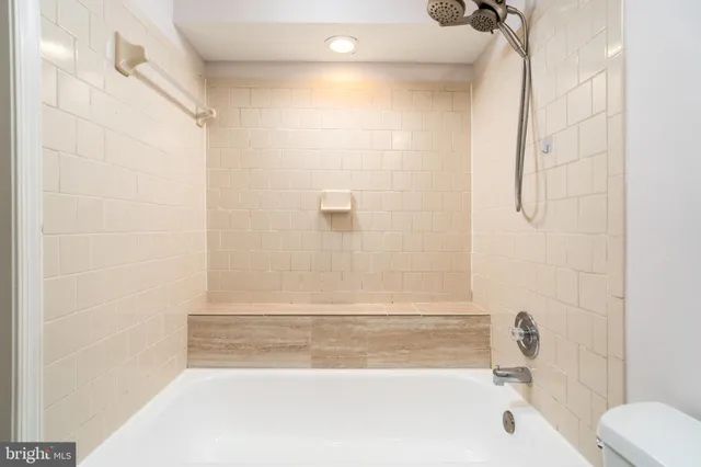 a bathroom with a shower and a bath tub