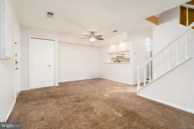 a view of an empty room with a ceiling fan