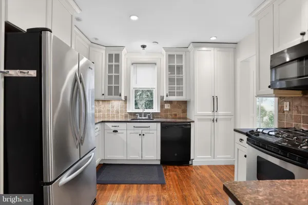 a kitchen with a sink stove and microwave