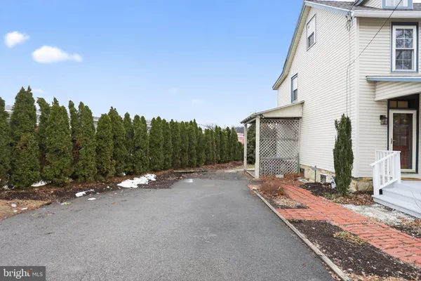 a backyard of a house with table and chairs