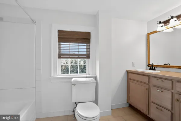 a view of a bathroom with toilet and shower