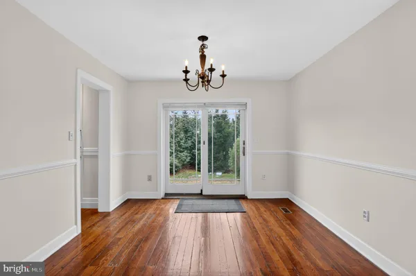 a view of an entryway with wooden floor