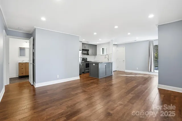 a view of a kitchen with a sink and a refrigerator