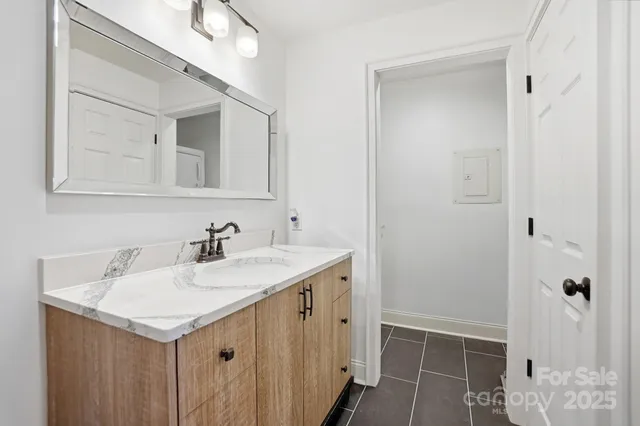 a bathroom with a sink vanity and a mirror
