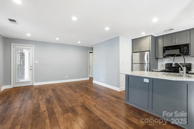 a view of a kitchen with a sink and a window