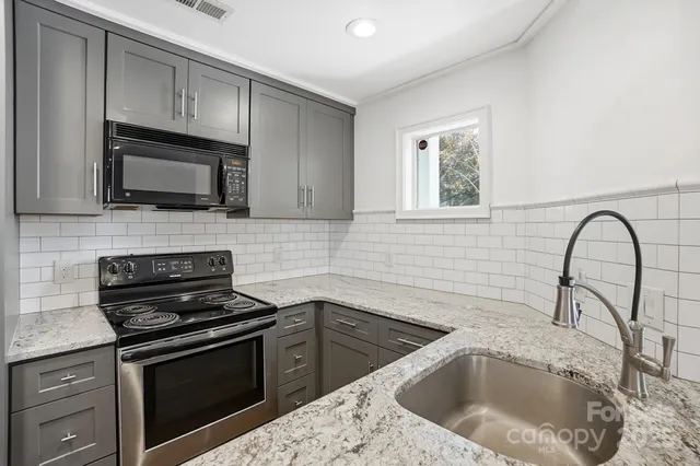 a kitchen with a sink stove and microwave
