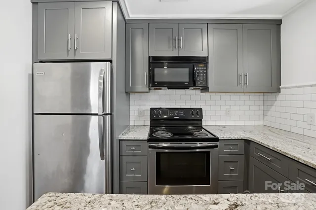 a kitchen with a refrigerator stove and microwave