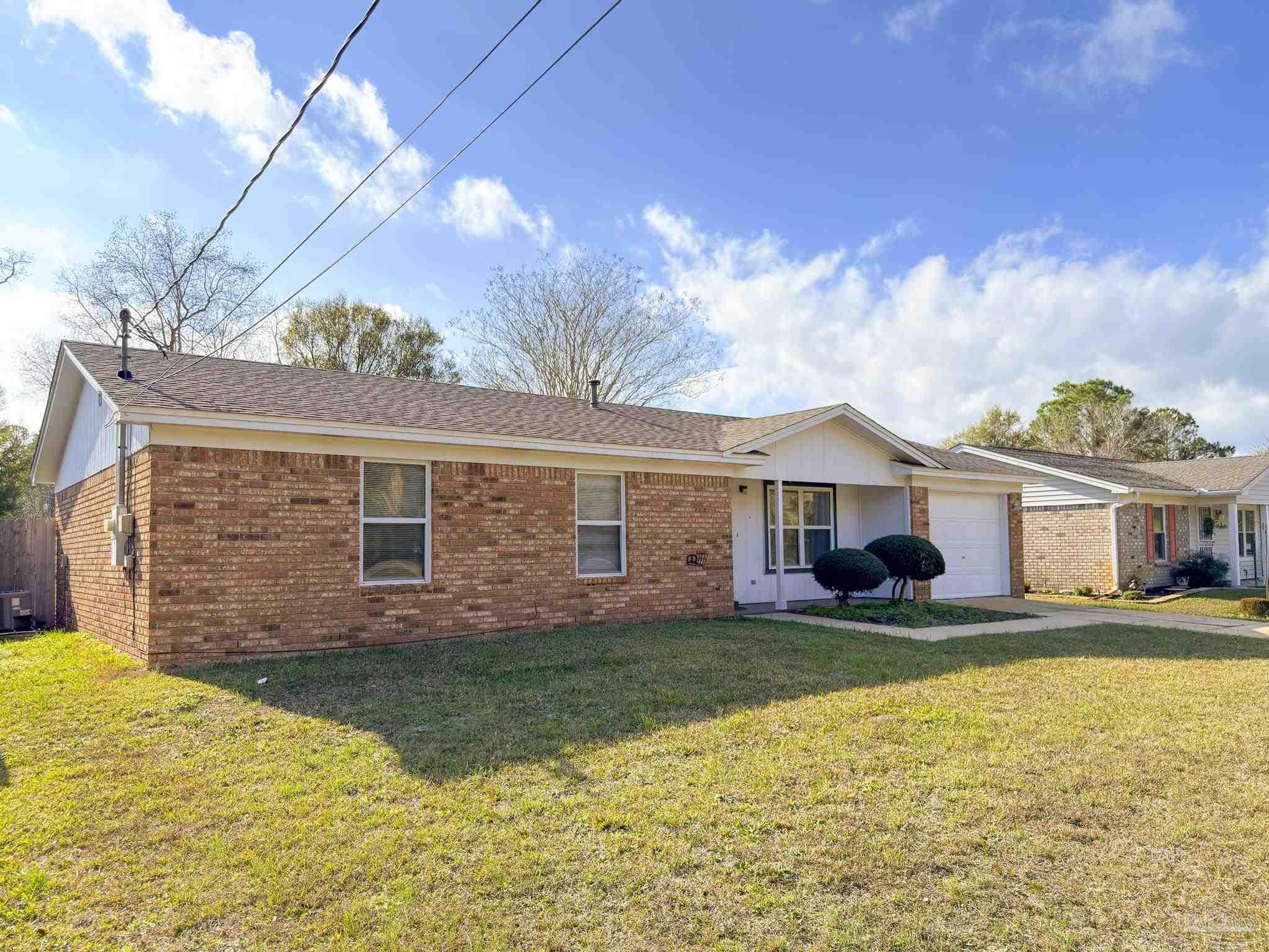 1341 Dog Track Road Pensacola, FL 32506 - Photo 25 of 26 a front view of a house with a yard