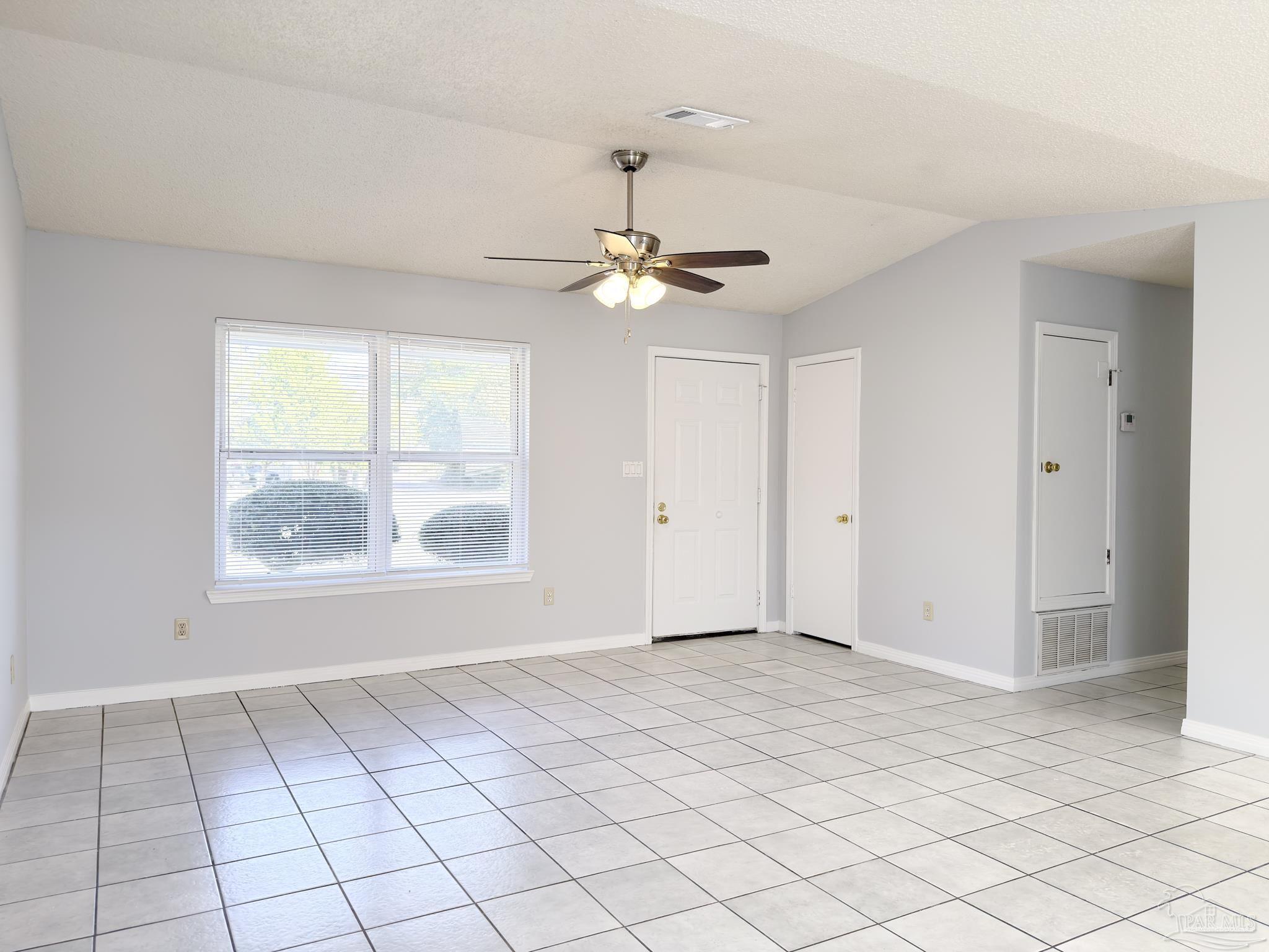 1341 Dog Track Road Pensacola, FL 32506 - Photo 5 of 26 an empty room with windows and fan