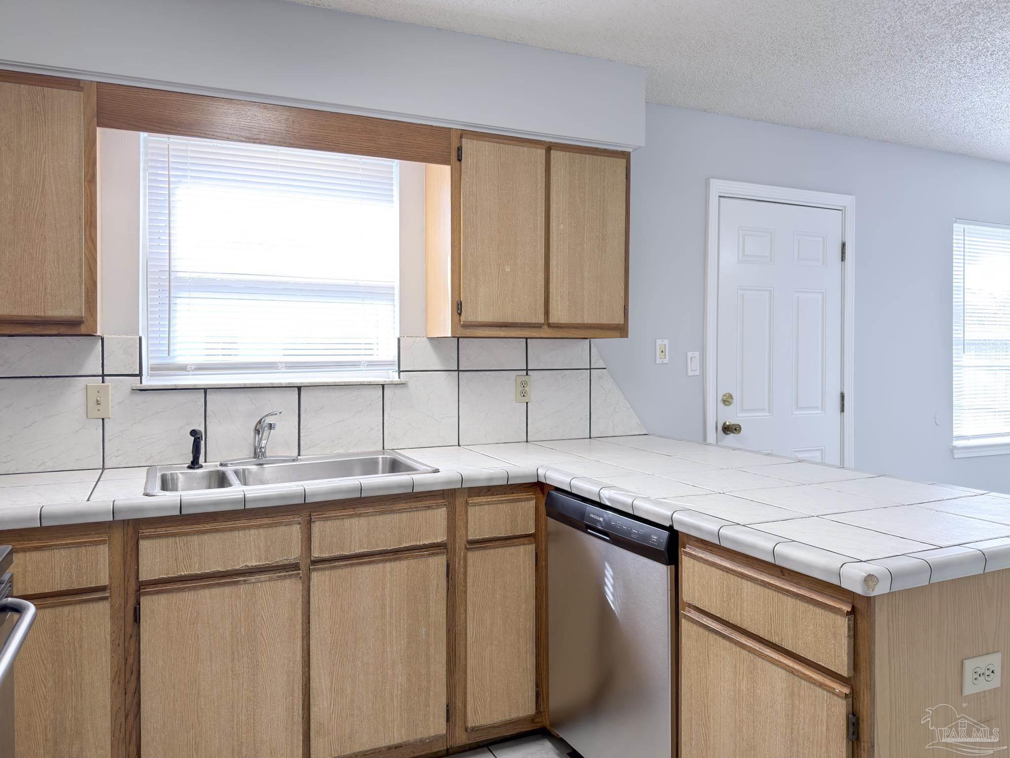 1341 Dog Track Road Pensacola, FL 32506 - Photo 7 of 26 a kitchen with a sink cabinets and window