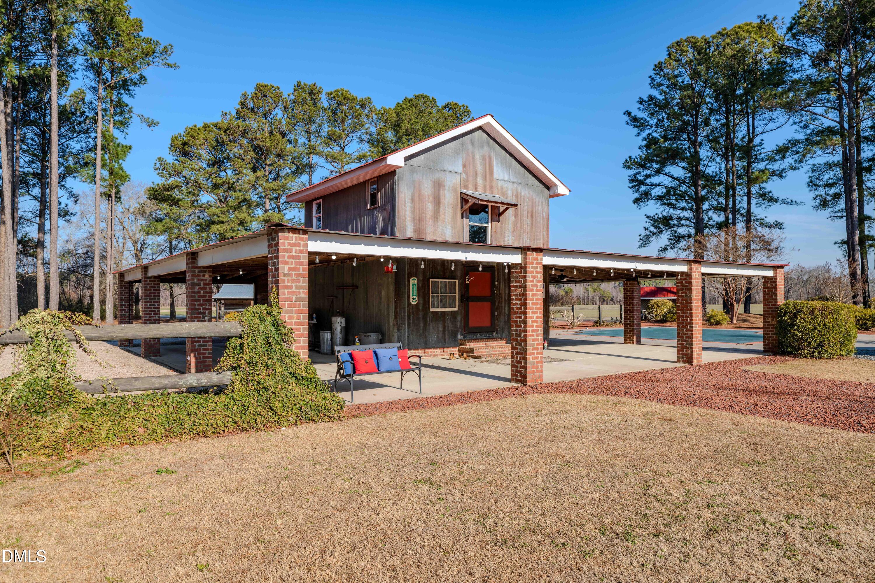 613 Will Lucas Road Linden, NC 28356 - Photo 26 of 98 a view of a house with a yard and potted plants